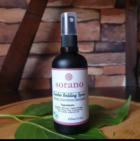 Sorano Organic Slumber Bedding Spray in a mist bottle, an aromatherapy pillow spray with lavender and chamomile for deep sleep.